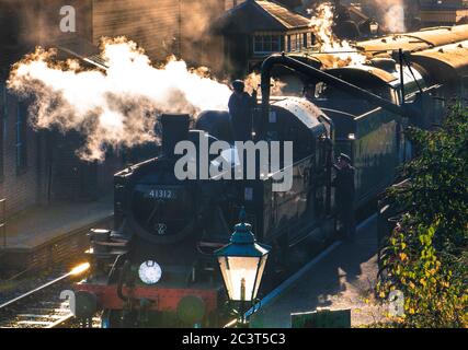 41312 - British Railways Ivatt Class 2MT Tank Engine takes on water at Ropley Station on The Mid Hants Railway.The BR Standard Class 2 tanks were also Stock Photo