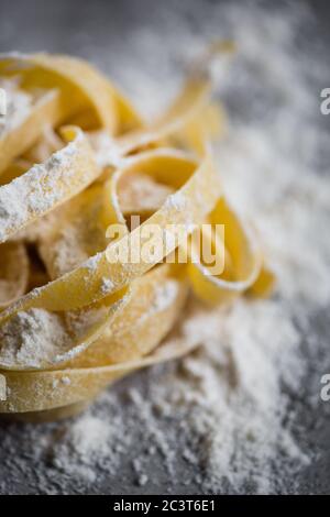 Homemade tagliatelle pasta on rustic board Stock Photo