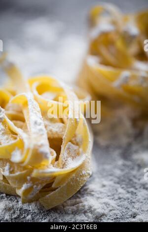 Homemade tagliatelle pasta on rustic board Stock Photo