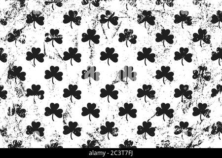 Grunge pattern with icons of shamrocks. Horizontal black and white backdrop. Stock Vector