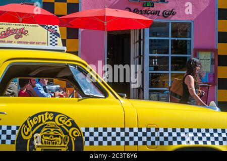 1950 Studebaker yellow taxi outside the Caliente Cab Mexican restaurant on Seventh Avenue, Greenwich Village, New York City, USA. Stock Photo