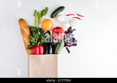 Healthy vegetarian vegan clean food in paper bag vegetables and fruits on stone background. Shopping supermarket and organic vegan diet concept Stock Photo