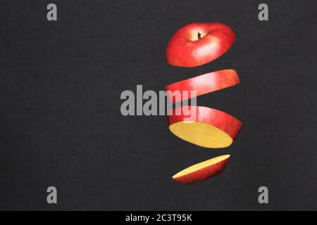 Diet concept, flying red apple slices. photo isolate on black copy space Stock Photo