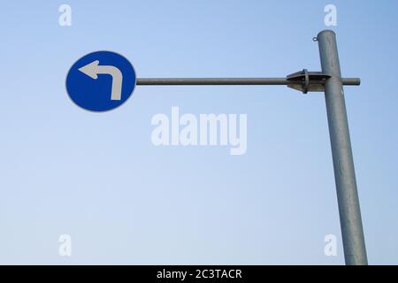 high hung blue left turn sign. Stock Photo