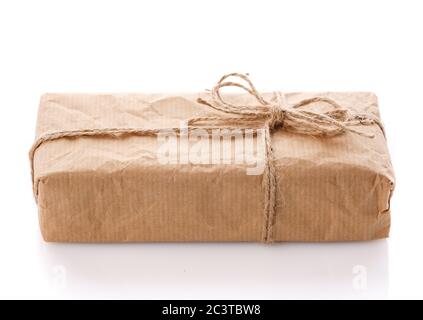 Parcel wrapped in brown kraft paper isolated on white background. Stock Photo