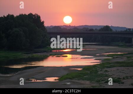 sun setting on the Loire river, France and reflecting in the water Stock Photo