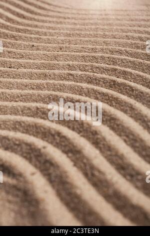 Sand on the beach close up. Wavy texture sand. Stock Photo