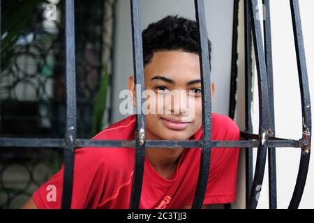 SANTO DOMINGO, DOMINICAN REPUBLIC - DECEMBER 21: The yang man is standing in colonial window in Santo Domingo town on December 21, 2018 Stock Photo
