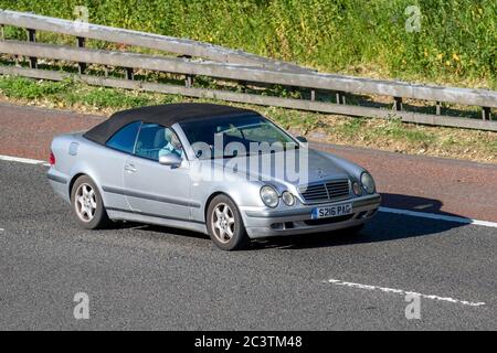 1998 90s nineties silver Mercedes Benz convertible; Vehicular traffic moving vehicles,  driving vehicle on UK roads, motors, motoring on the M6 motorway Stock Photo