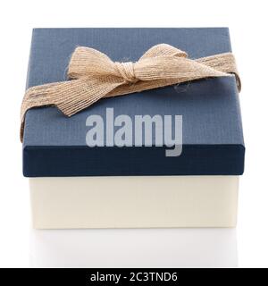 Cardboard box on a white background. Gift box with sacking ribbon. Stock Photo