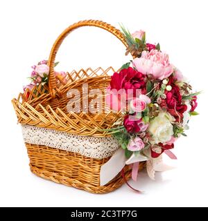 Very beautiful original brown wicker basket decorated with pink and white peonies. Ribbons and lace. Stock Photo
