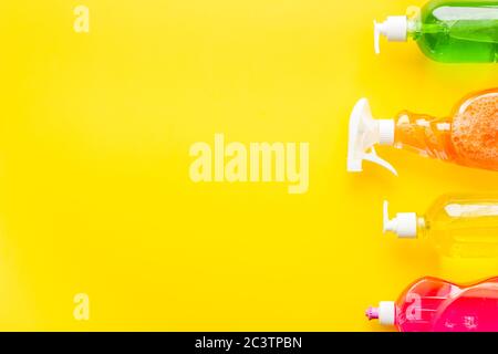 Cleaning products bottles on yellow background top view copy space Stock Photo