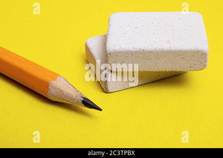Two erasers and pencil on a yellow background Stock Photo
