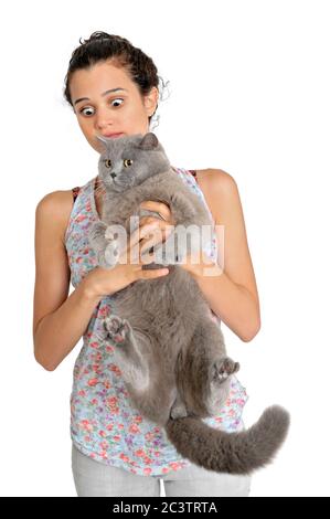 surprised owner as she holds a British Shorthair (AKA Britsh blue) cat Stock Photo