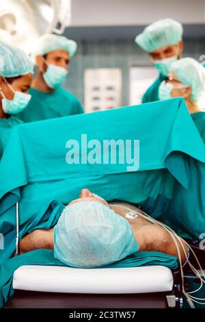 Team surgeon at work in operating room. Stock Photo