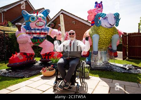 Disabled artist Jason Wilsher-Mills, who had been due to show his work at the Tate after winning the equivalent of the Turner Prize for disabled artists, has found new ways to work while self-isolating during the coronavirus pandemic by putting his giant inflatable sculptures on display in the back garden of his home in Sleaford, Lincolnshire. Stock Photo