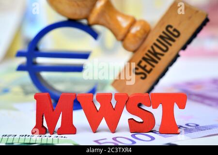 PHOTOMONTAGE letters form the acronym of VAT in front of a