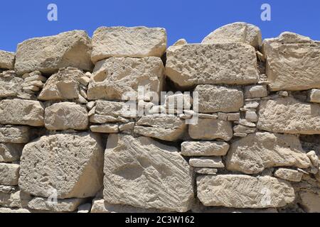 old stonewall on blue sky background. Take it in Amathus antique city in Cyprus Stock Photo