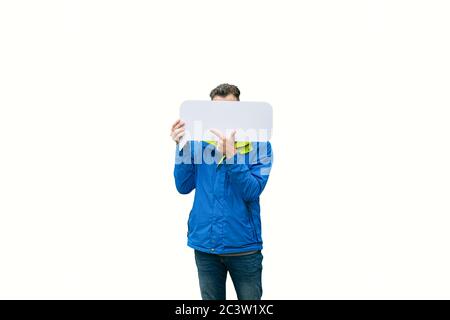model man hiding his face behind blank white sheet and points finger to signboard. Stock Photo