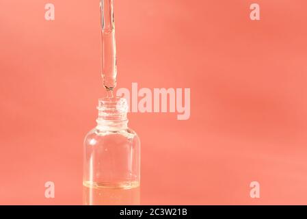 Natural Serums. Concept of cosmetic injection is hyaluronic acid, botulinum, serum. Cosmetic pipette with drops of cosmetic oil or liquid gel close-up Stock Photo