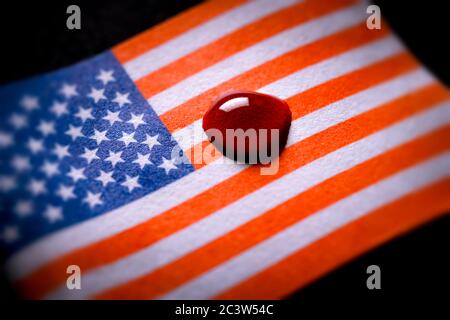 Drops of blood on flag of the United States, violent riots after police violence in the US, Blutstropfen auf Fahne von der USA, gewaltsame Ausschreitu Stock Photo