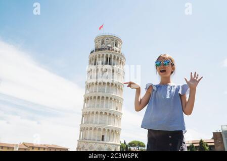 Happy child girl pointing Leaning Tower of Pisa