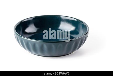Empty dark blue ceramic bowl isolated on a white background. Clay, ceramics or porcelain crockery and tableware. Front view. Stock Photo