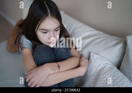 Sad teenager feeling bad alone, feeling depressed, regrets of mistake, having problems, adolescent girl with broken heart Stock Photo