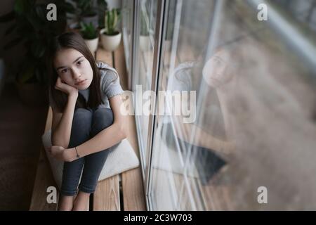 Sad teenager feeling bad alone, feeling depressed, regrets of mistake, having problems, adolescent girl with broken heart Stock Photo