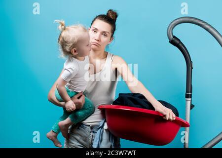 Tired mother with a small child wearily looks at the camera Stock Photo