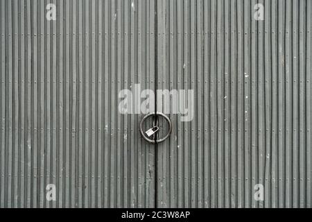 Grungy weathered grey metallic doors. Old weathered iron gate. Stock Photo