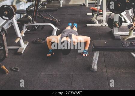 Sport man doing push ups exercise in gym. Workout concept. Fitness concept Stock Photo