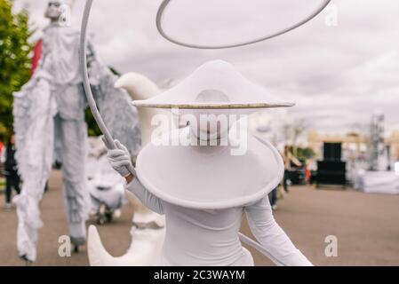Street actor in a white suit with his face covered. Festival, masquerade or celebration on the street. Russia, Moscow - September 10, 2016 Stock Photo