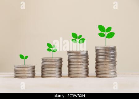 Silver coins arranged in a graph with there are trees on top. Stock Photo