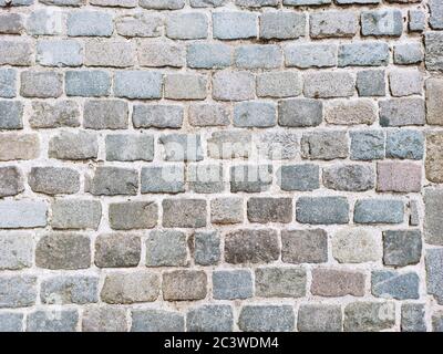 Abstract cobblestone floor. Abstract background with stone texture from above. Stock Photo
