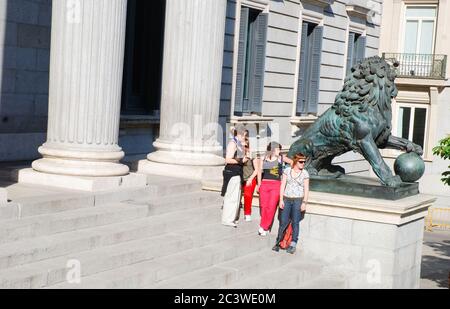 Group of people by the lion sculpture. Congreso de los Diputados, madrid, Spain. Stock Photo