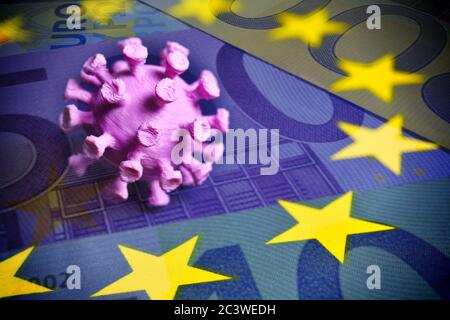 PHOTOMONTAGE, coronavirus miniature on EU flag with banknotes, FOTOMONTAGE, Coronavirus-Miniatur auf EU-Fahne mit Geldscheinen