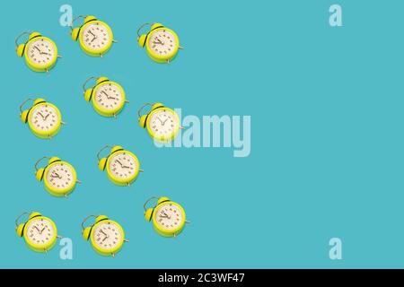A lot of classic style alarm clock isolated on light blue background and copy space. Smile time concept Stock Photo