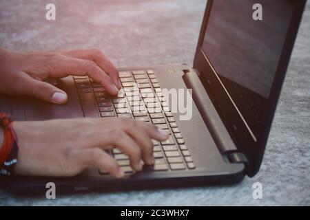 Man hands typing on laptop keyboard Stock Photo
