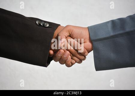 Business and office concept - Two confident business man shaking hands during a meeting Stock Photo