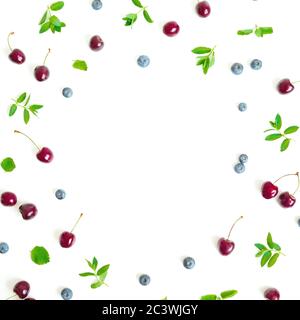Cherry and bluebery with mint isolated on white background. Top view. Flat lay berry frame Stock Photo