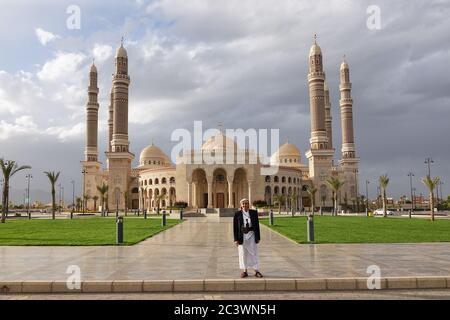 Sanaa, Yemen - March 6, 2010: Unidentified local man in traditional dress with dagger shown in front of the AL-Saleh mosque Stock Photo