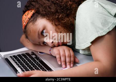 Tired girl working on a laptop Stock Photo
