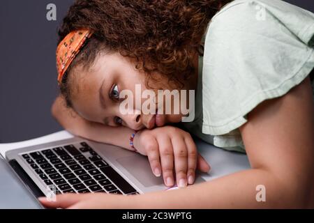 Tired girl working on a laptop Stock Photo