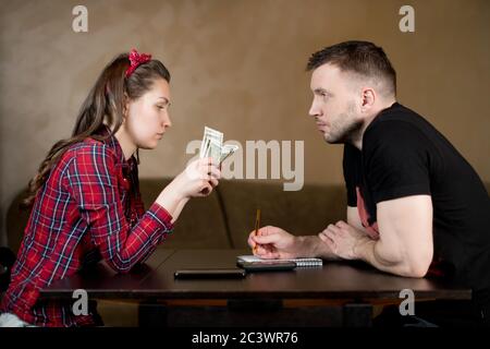 Husband and wife count money in the kitchen. Difficult time, crisis, job loss Stock Photo