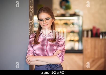 Beautiful waitress standing in cafe. waiting for customer Stock Photo