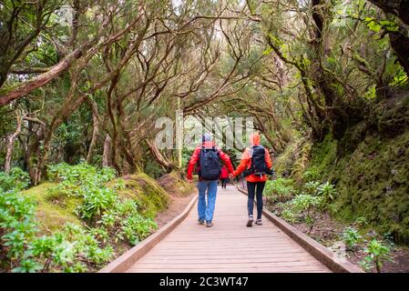 Sporty tourist couple on hiking trail in Anaga Rural Park - ancient rain forest on Tenerife, Canary Islands. Stock Photo