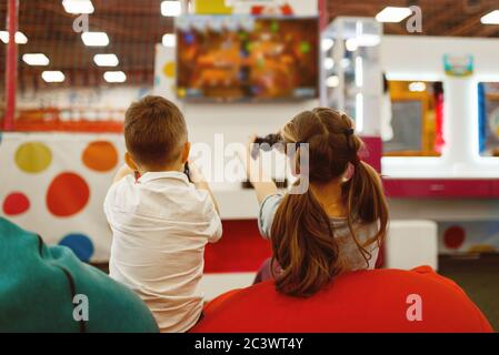 Children plays game console, entertainment center Stock Photo