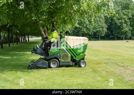 Glasgow, Scotland, UK. 22nd June, 2020. A gardener mowing the grass in Glasgow Green. The Scottish Government announced on 18th June a further easing of the coronavirus lockdown rules with the start of phase two of a four part transition out of lockdown. Credit: Skully/Alamy Live News Stock Photo