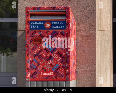 Toronto Canada, June 17, 2020; A Canada Post mail drop red postbox with graphic postal code decoration Stock Photo